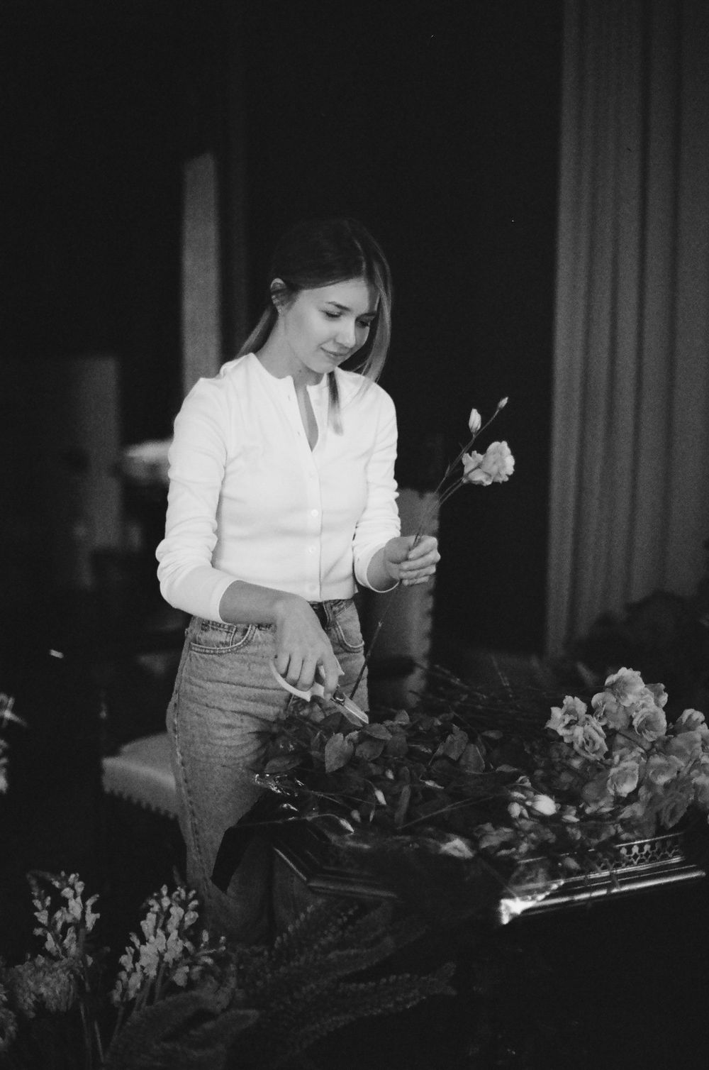 A florist tying a fresh bouquet of garden flowers